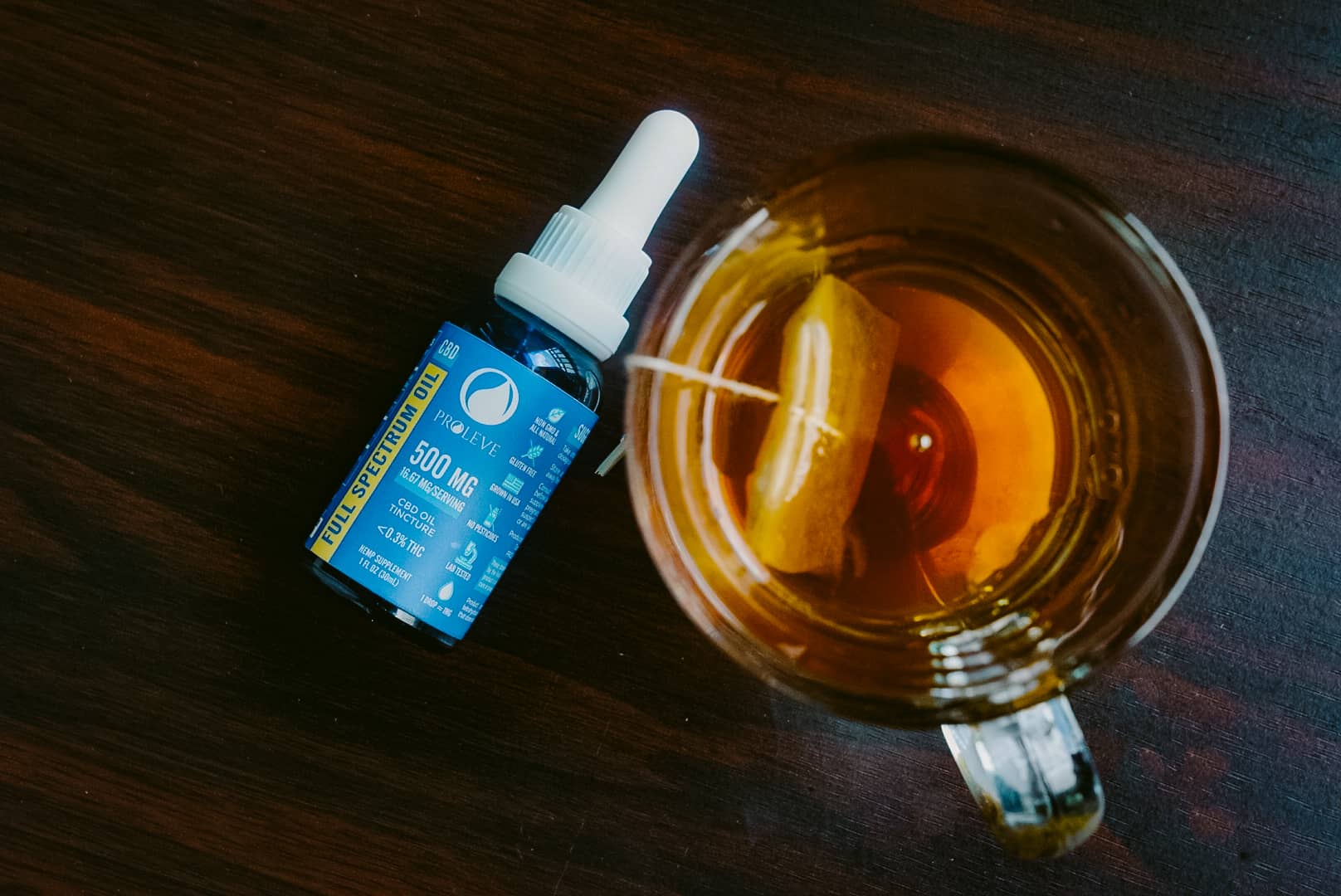 CBD Oil Tincture Pictured with cup of tea